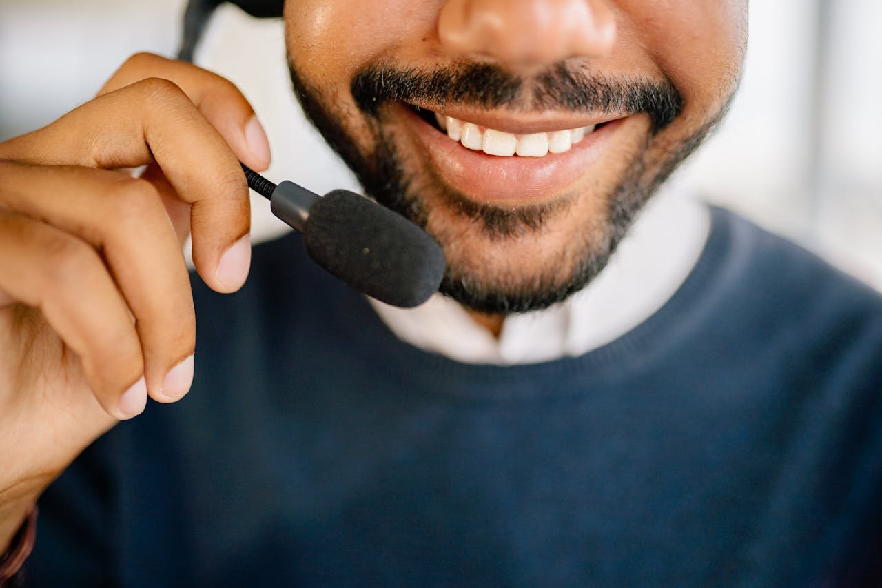 A cheerful call center agent wearing a headset and microphone, providing excellent customer service.